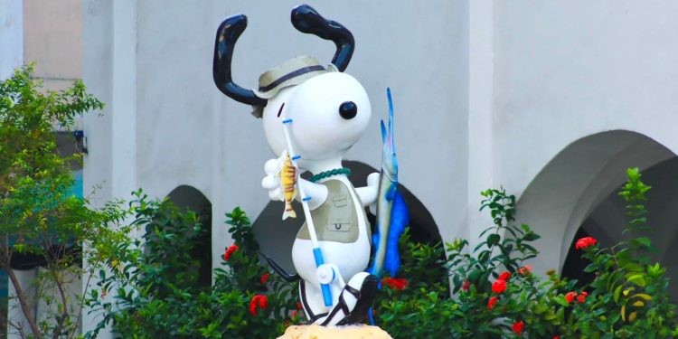 Turistas reciben a la emblemática estatua de Snoopy, completamente rehabilitada.